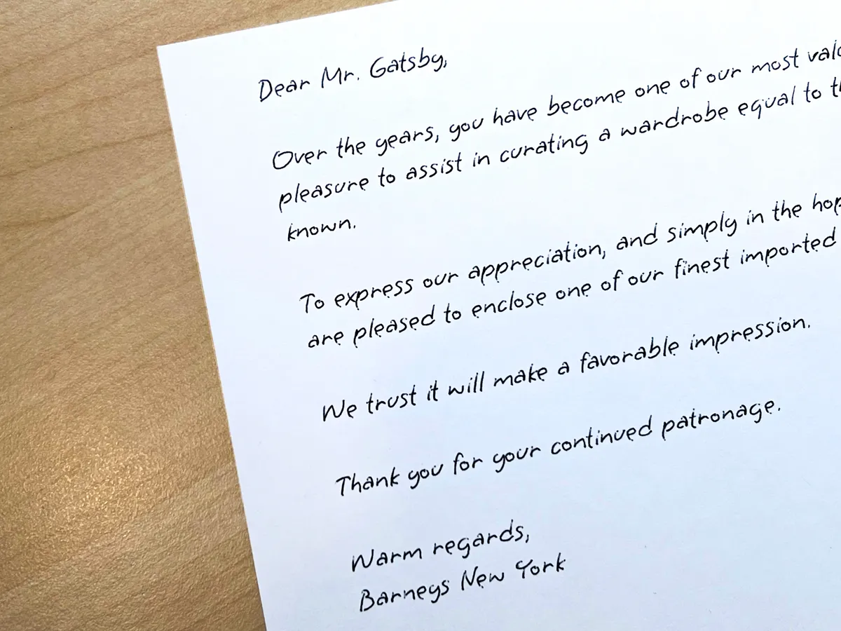 Handwritten customer appreciation letter addressed to Mr. Gatsby on a wooden table